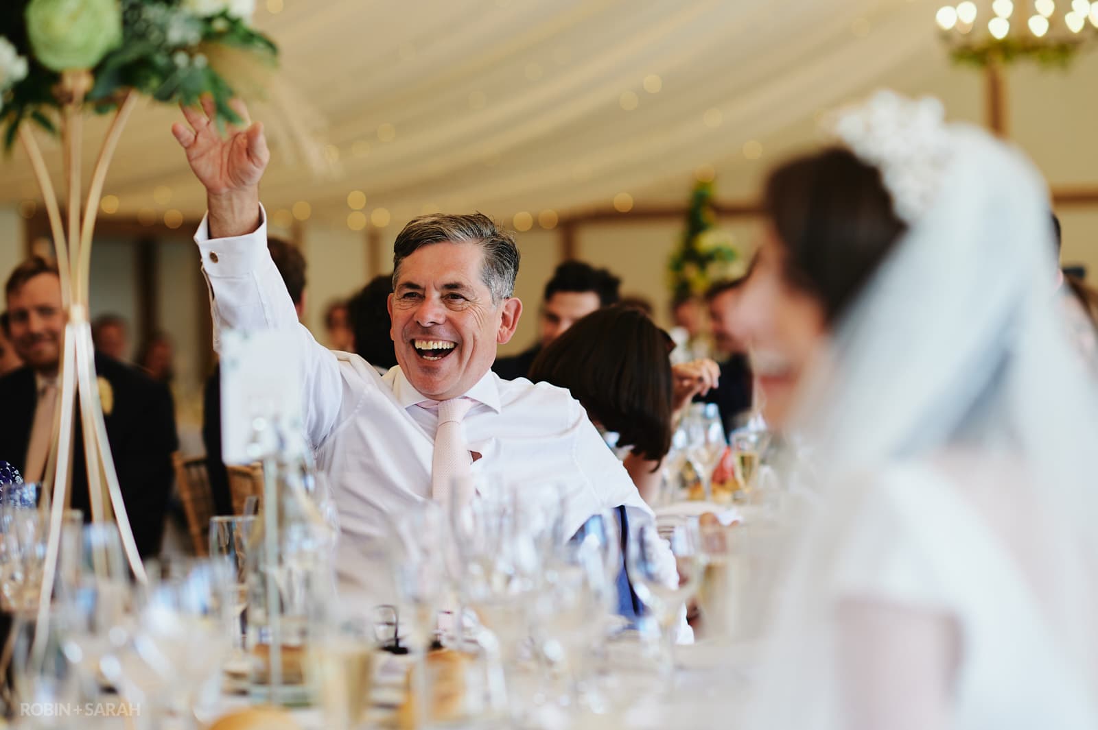 Wedding guests laughing during speeches