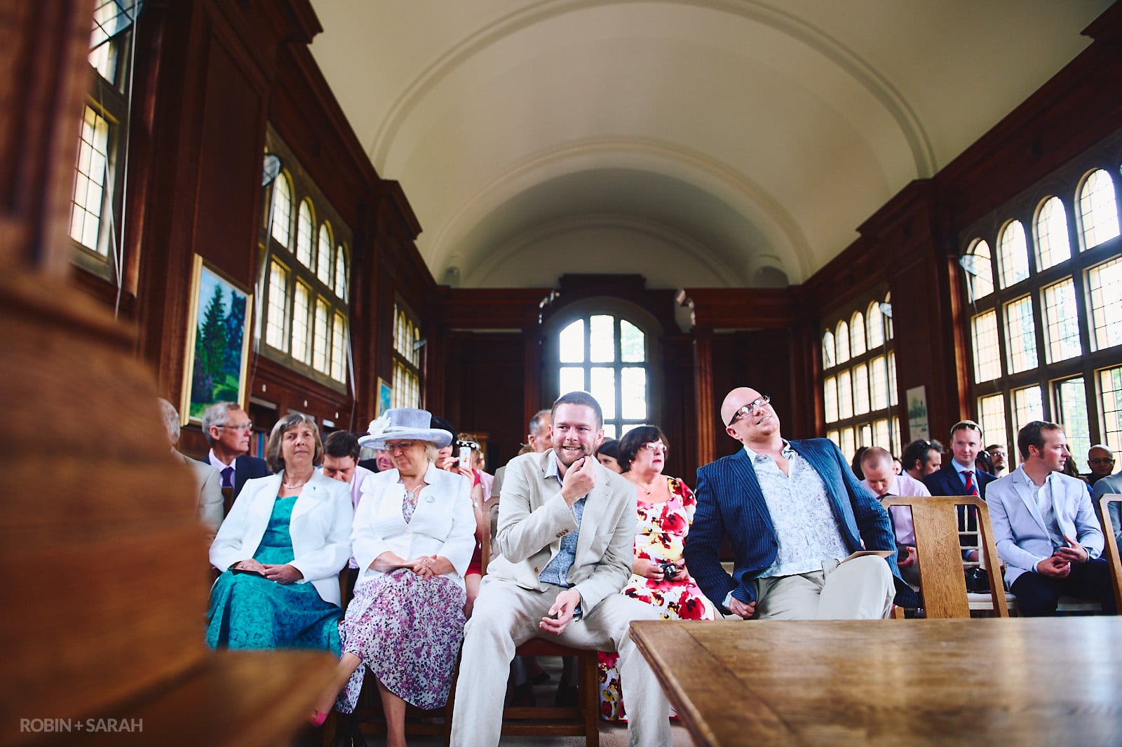 Groom and guests wait for start of wedding ceremony in Malvern College Memorial Library