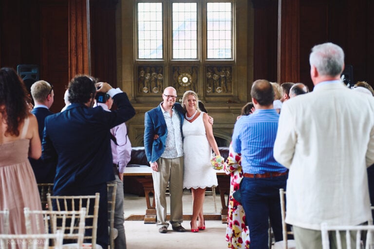 Bride and groom turn to face guests at end of marriage ceremony in Malvern College Memorial Library