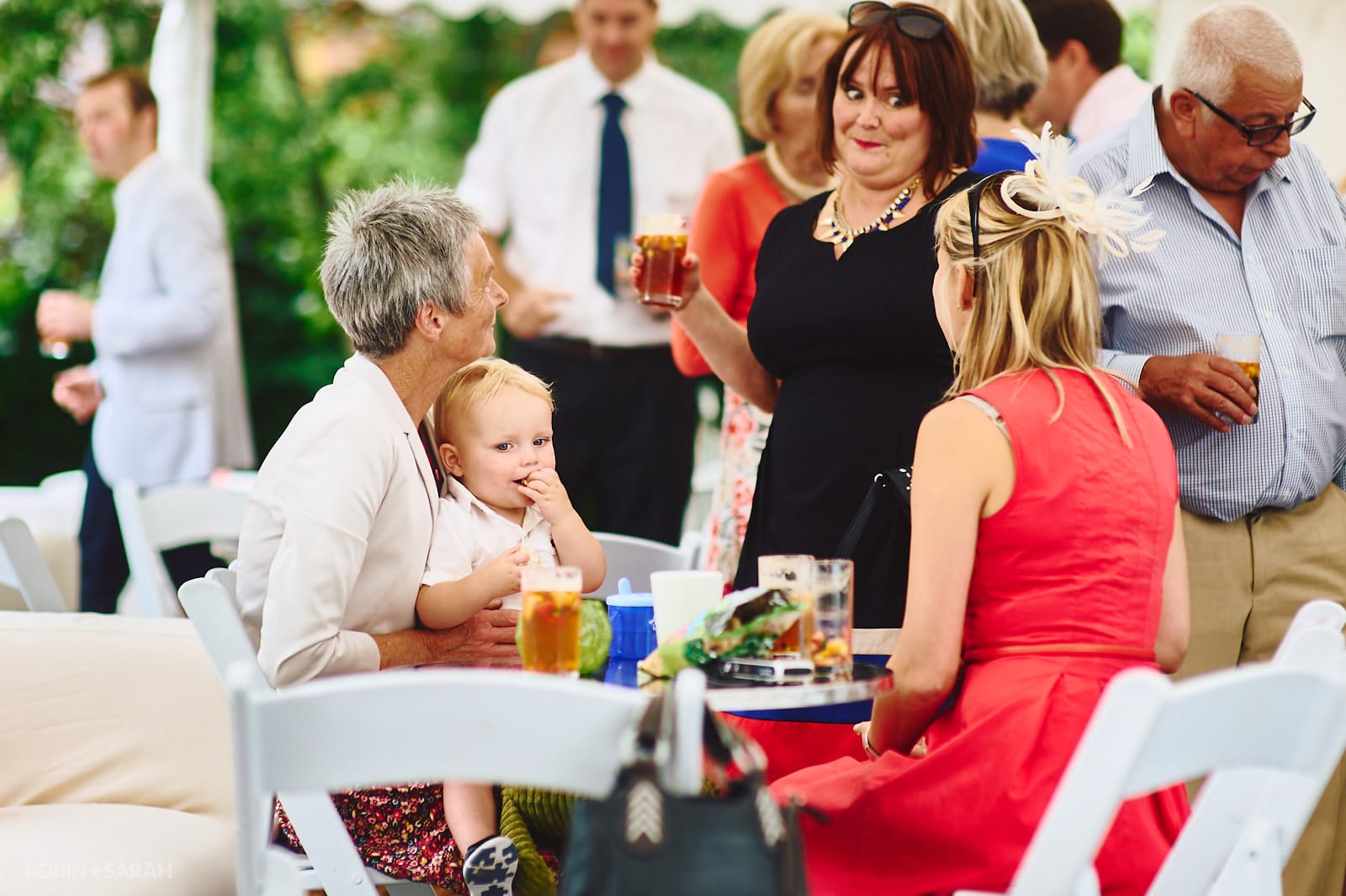 Guests chat and relax at home wedding reception