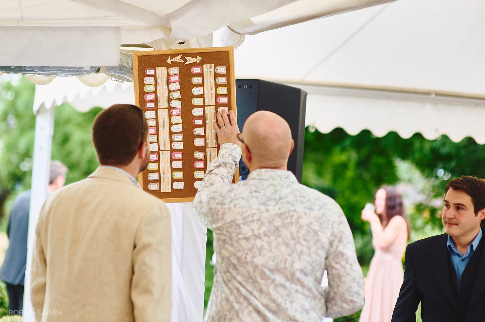 Wedding guests look at table plan