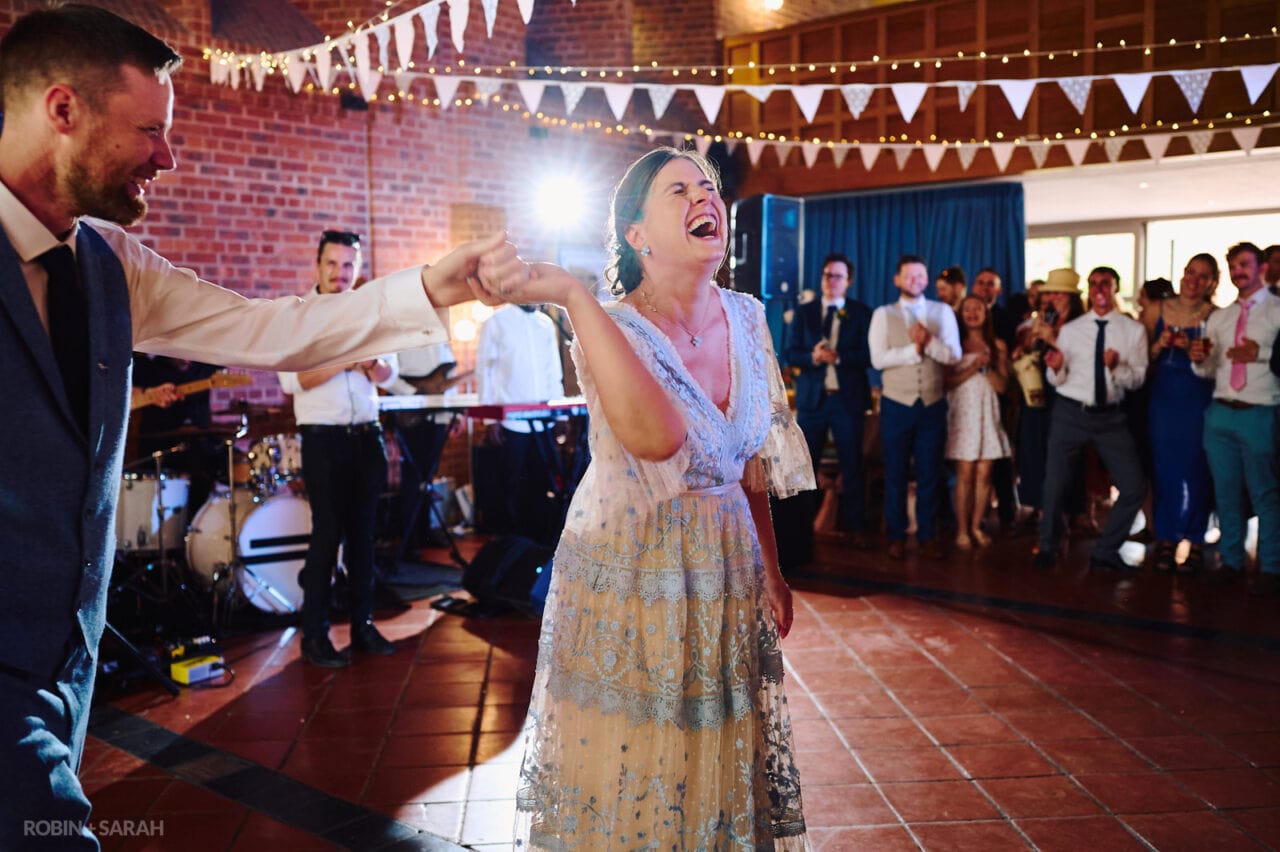 Bride and groom laughing during their first dance at Avoncroft Museum wedding