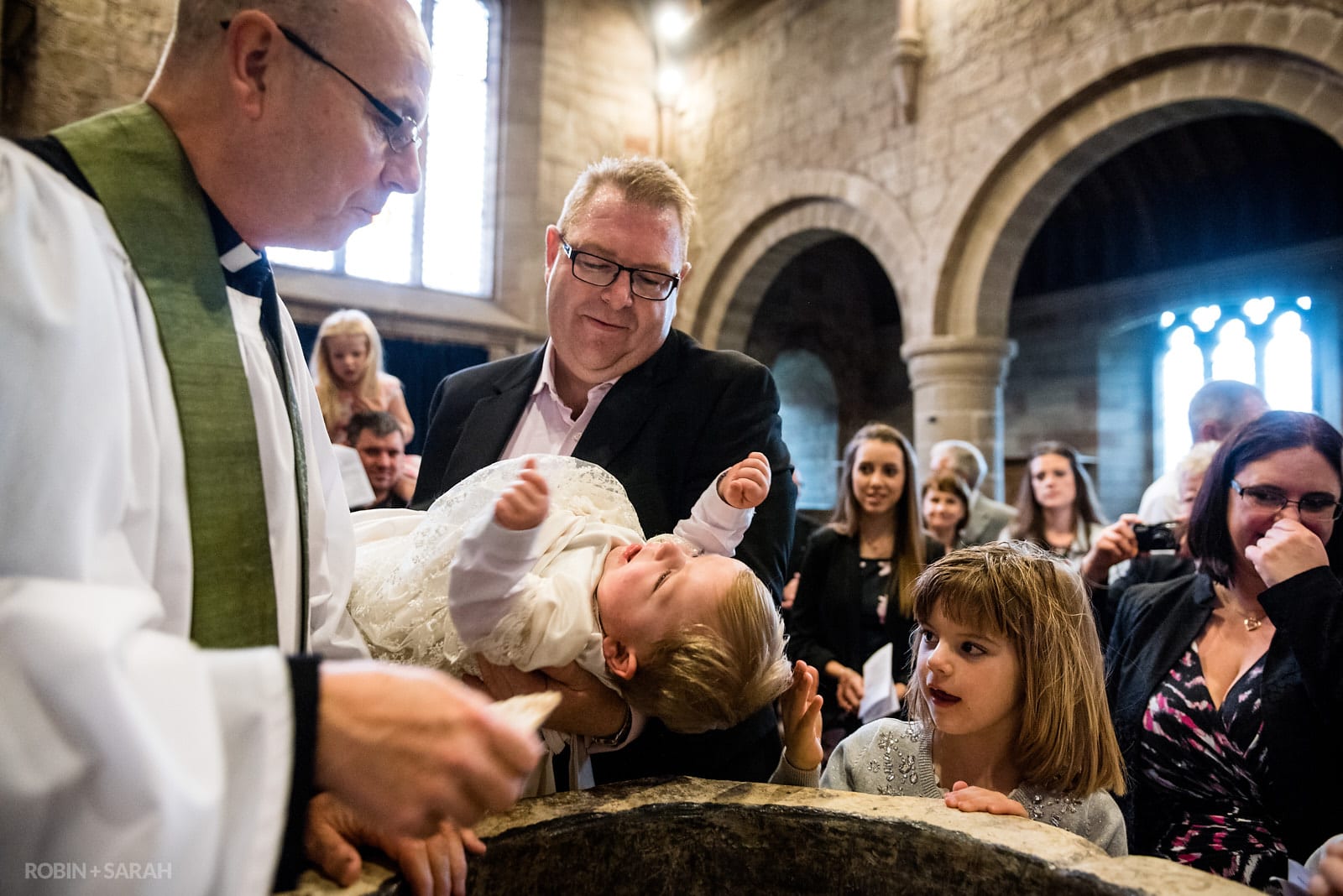 A young baby being christened in church