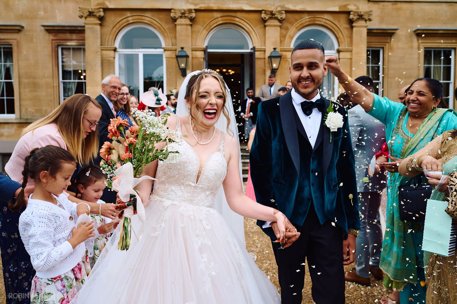 Bride and groom have confetti thrown over them at Spring Grove House
