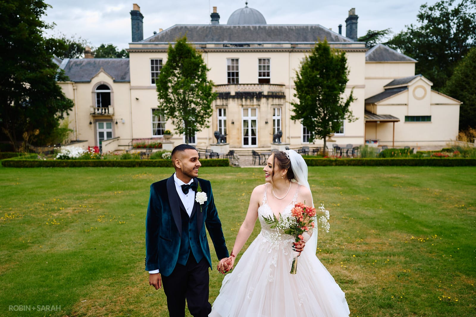 Bride and groom walk through grounds at Spring Grove House