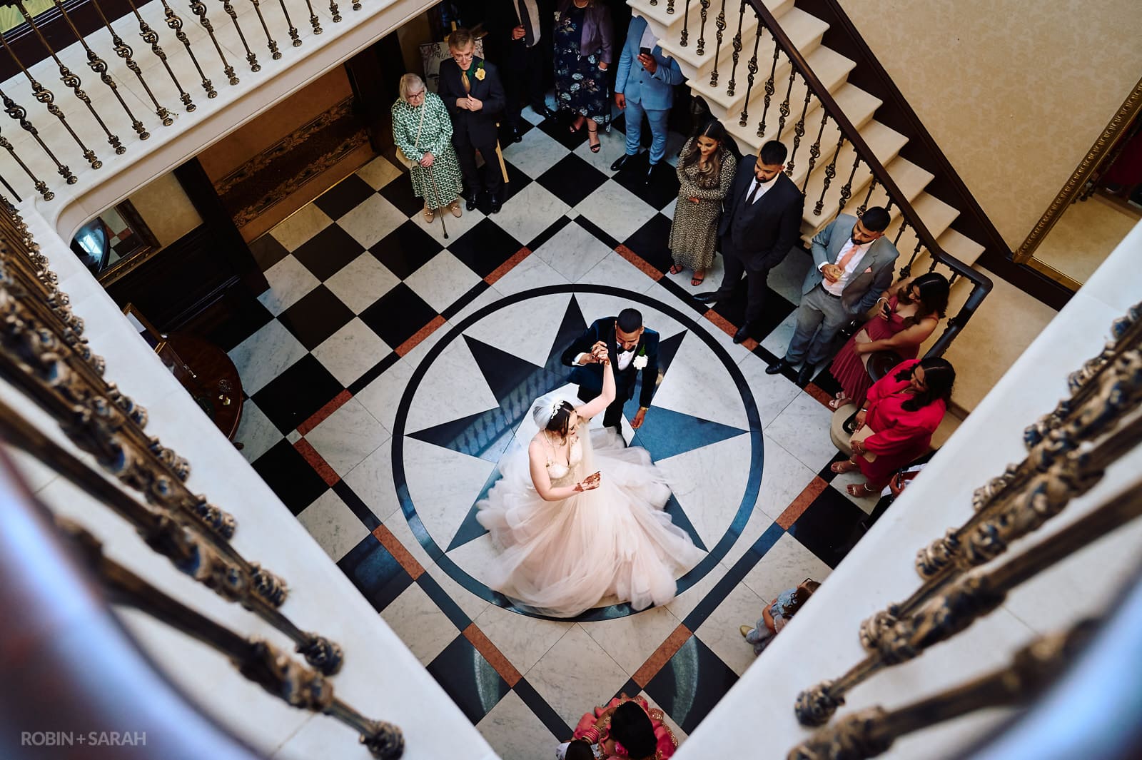 Bride and groom perform their first dance on marble floor at Spring Grove House