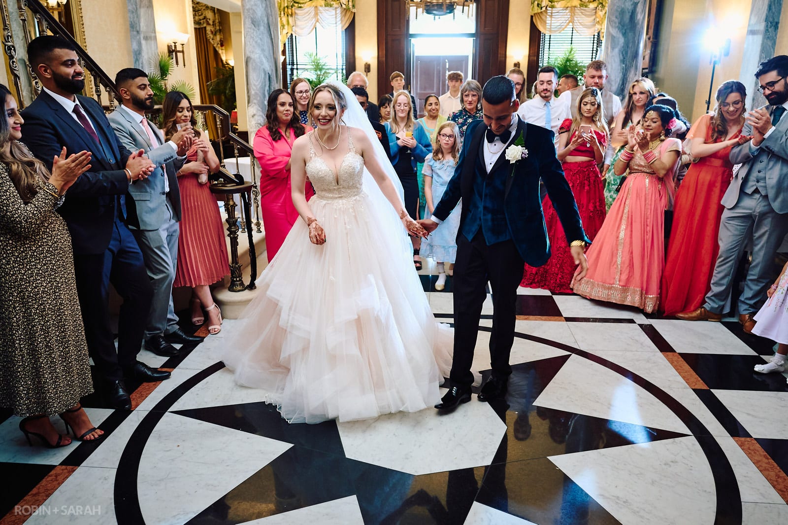 Bride and groom perform their first dance on marble floor at Spring Grove House