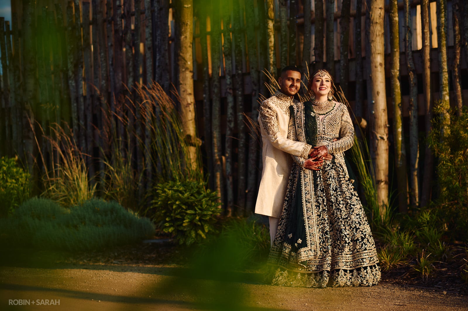 Bride and groom in Indian wedding outfits enjoy the sunshine at West Midlands Safari Park