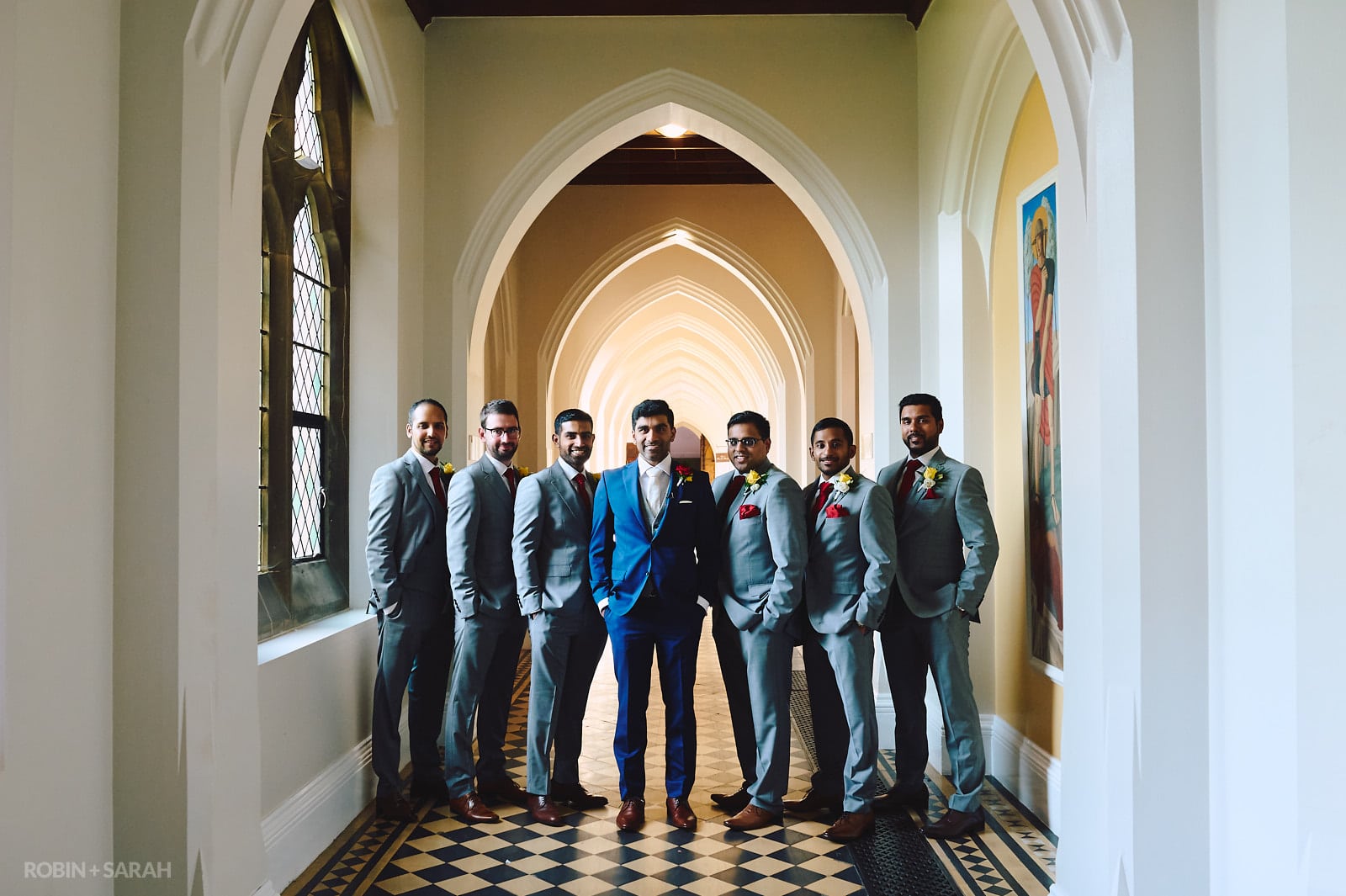 Wedding group photo in cloisters at Stanbrook Abbey, with groom and groomsmen