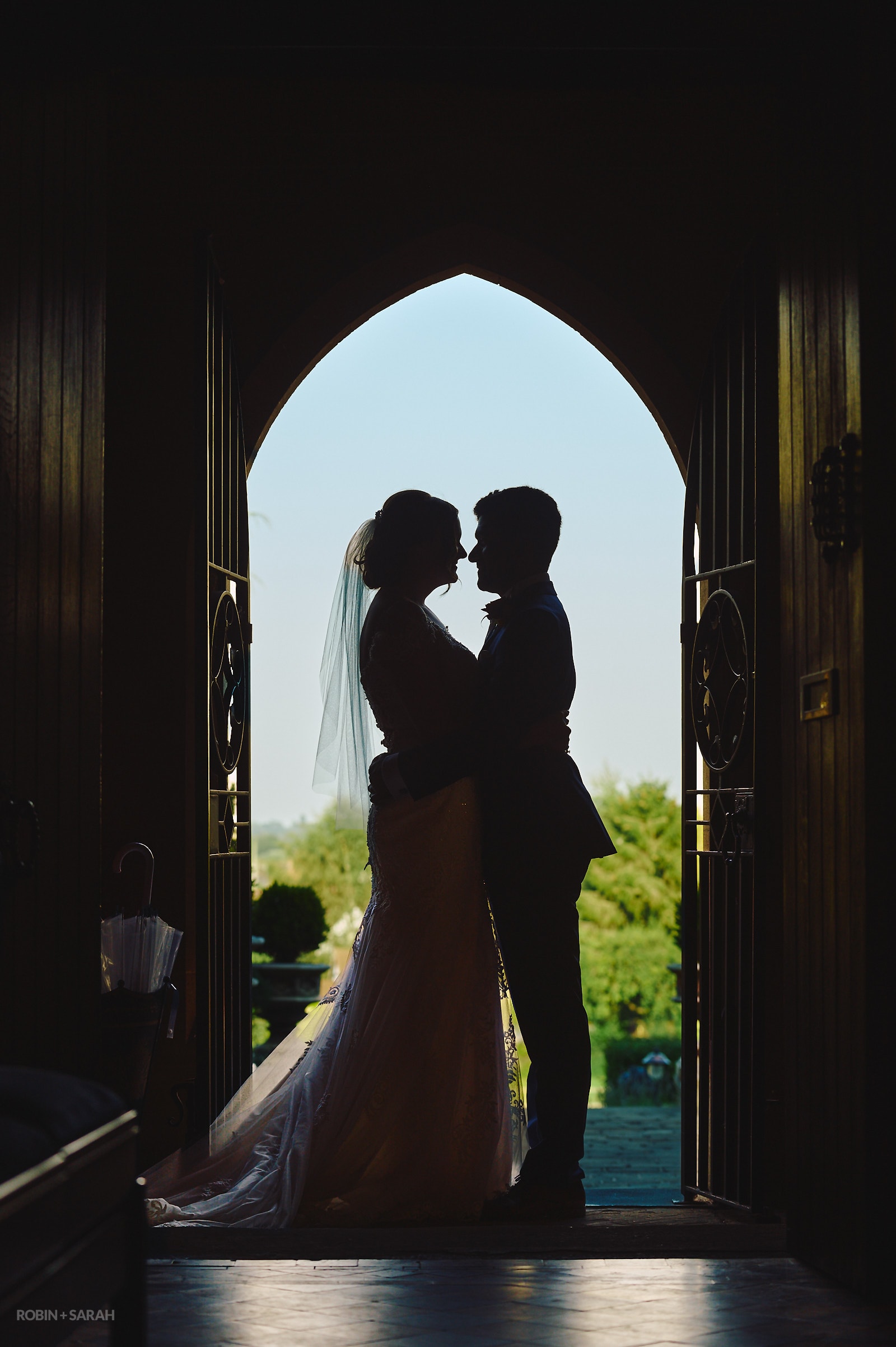 Bride and groom silhouetted in doorway