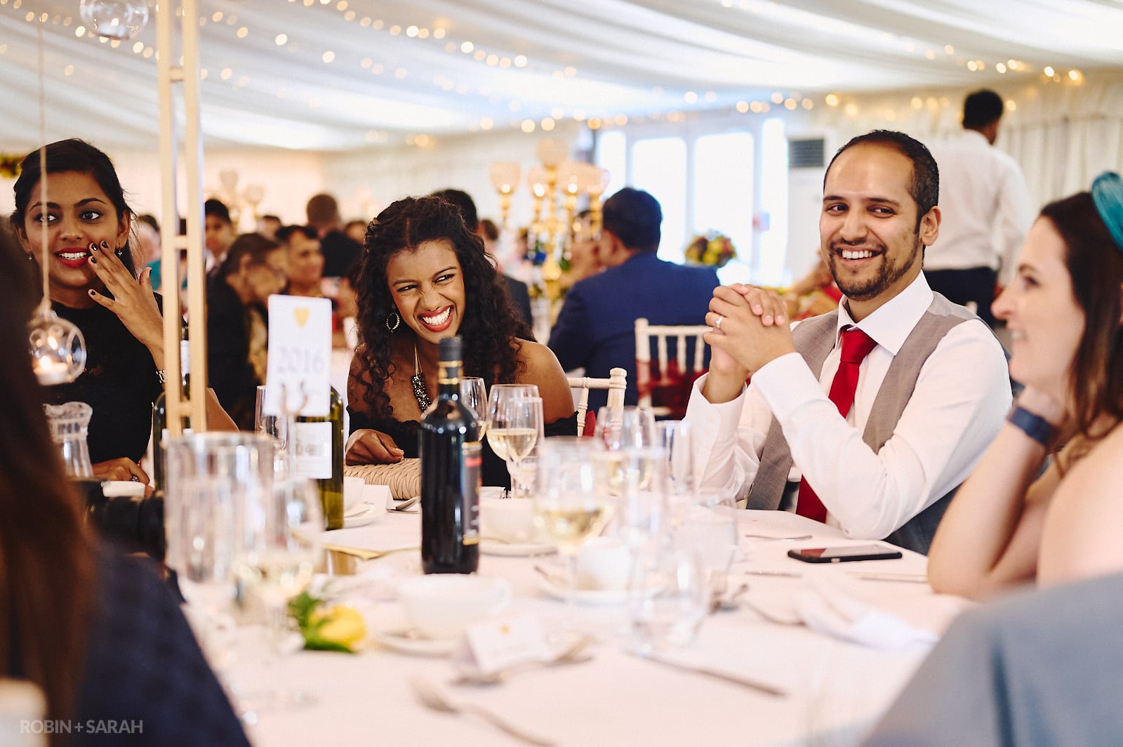 Guests chat and relax during wedding meal