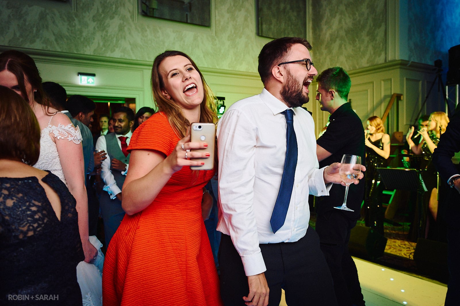 Wedding guests dancing in St Anne's Hall at Stanbrook Abbey
