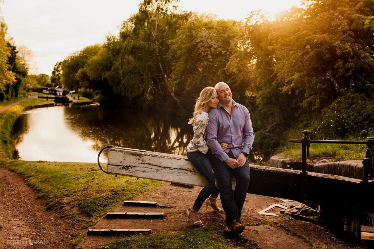 Engaged couple sitting on canal lock