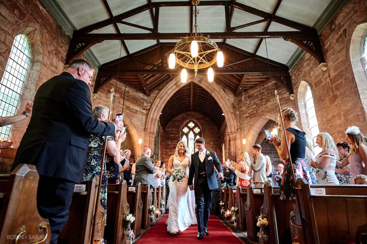 Bride and groom exit wedding ceremony at Christchurch Catshill