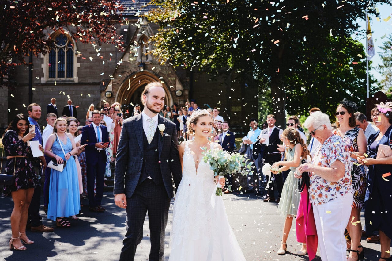 Newly married couple have confetti thrown over them outside St Peters Catholic church in Bromsgrove