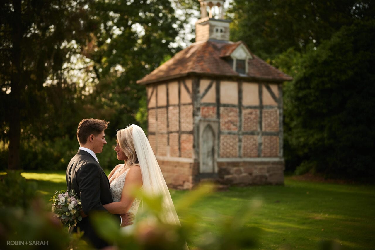 Bride and groom in grounds of Brockencote Hall