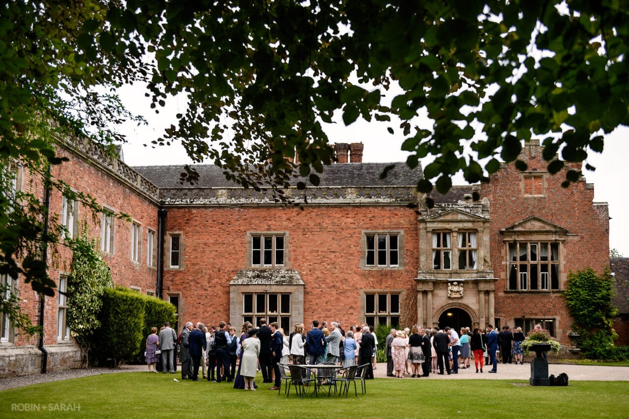 Wedding guests chat and relax during reception at Grafton Manor in Bromsgrove