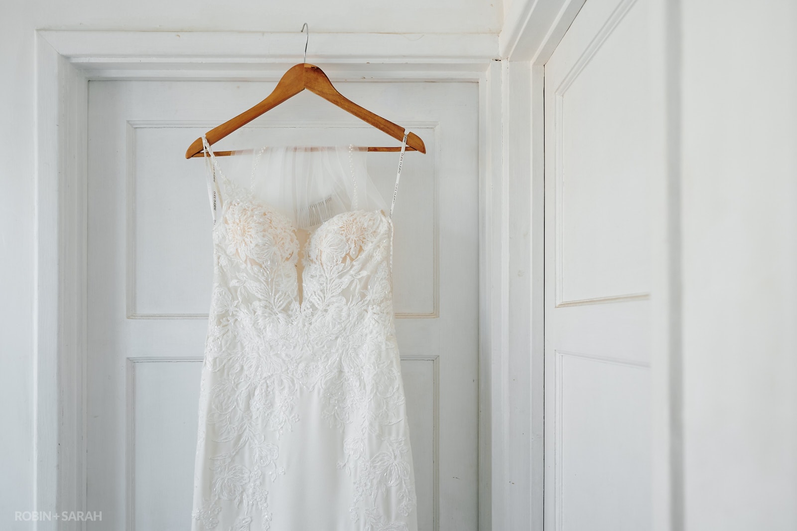 Wedding dress hanging on doorframe