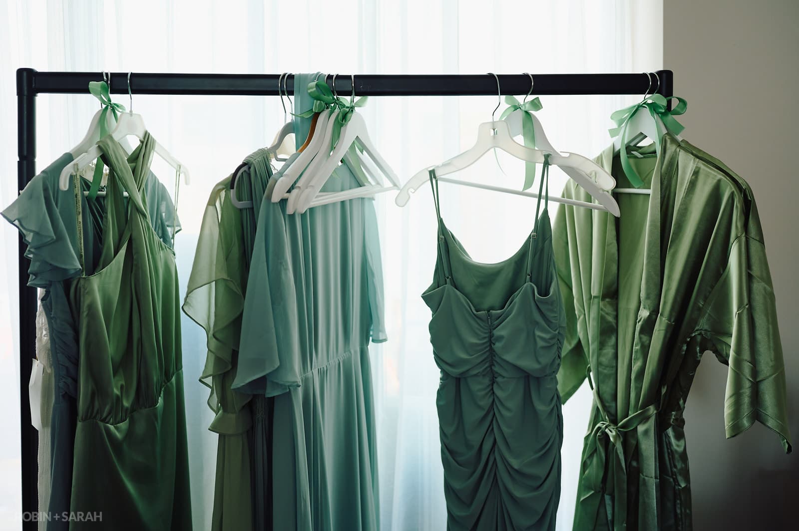 Green bridesmaids dresses on hangers