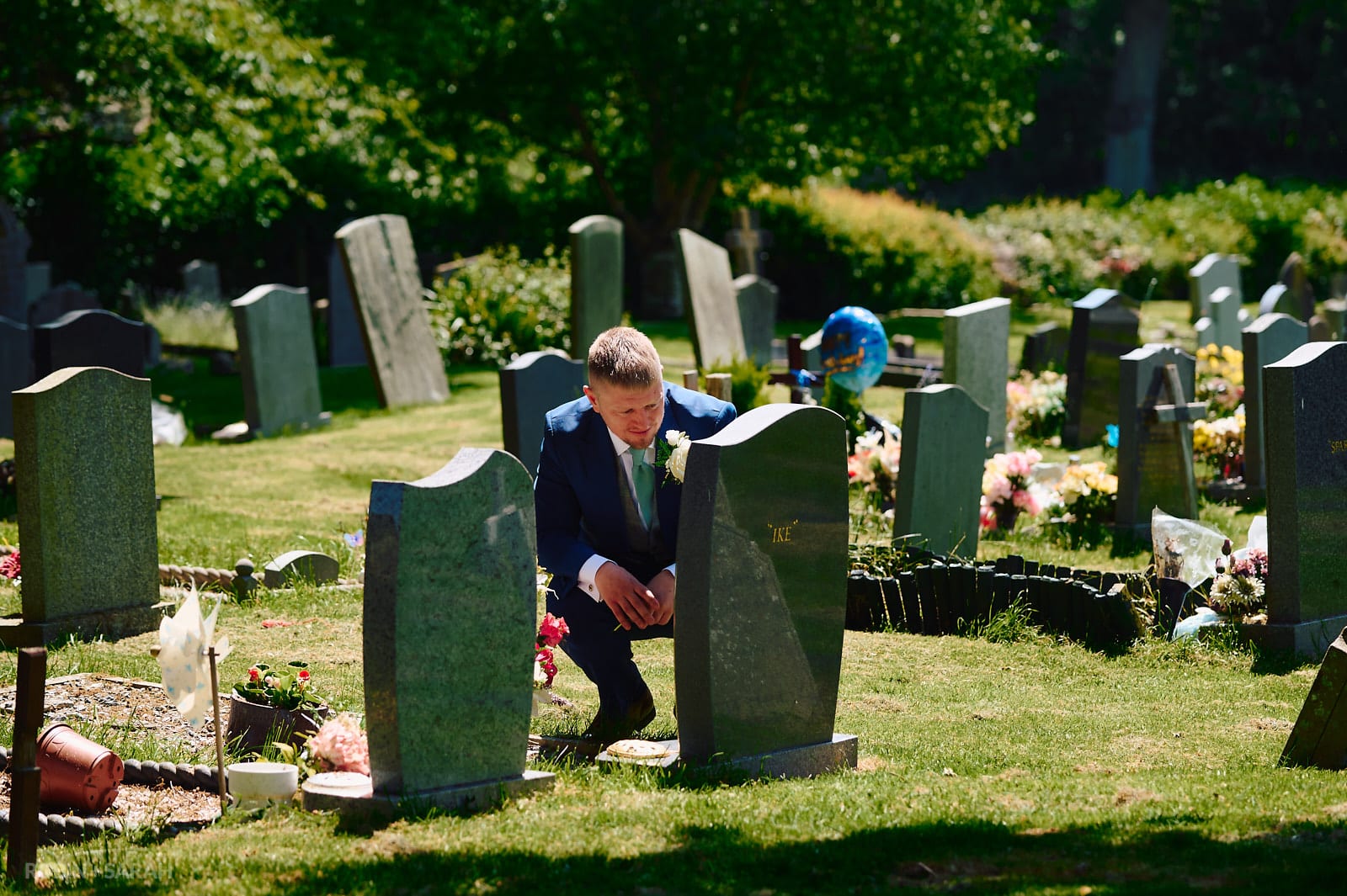 Groom visits grave of grandfather in churchyard before wedding