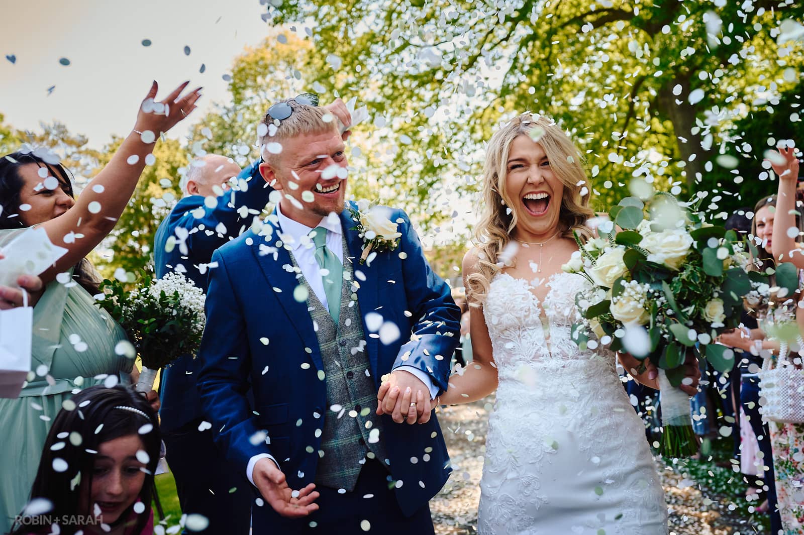 Bride and groom have confetti thrown over them at St Botolph's church Newbold-on-Avon