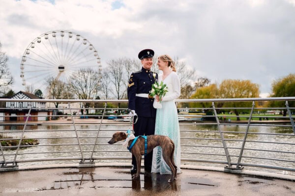 Bride and groom stand on bride in Stratford-upon-Avon with their dog