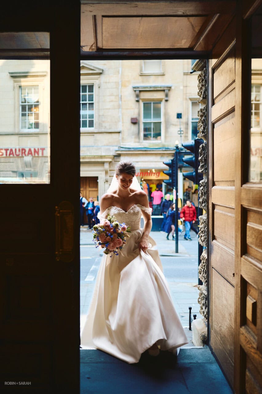 Bride walks into Bath Guildhall main entrance