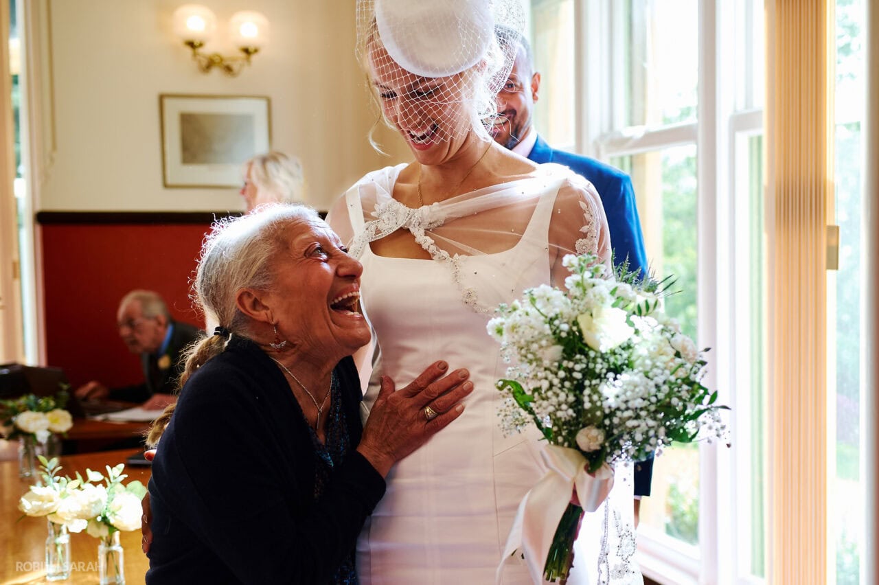 Bride and groom hug wedding guests at end of ceremony