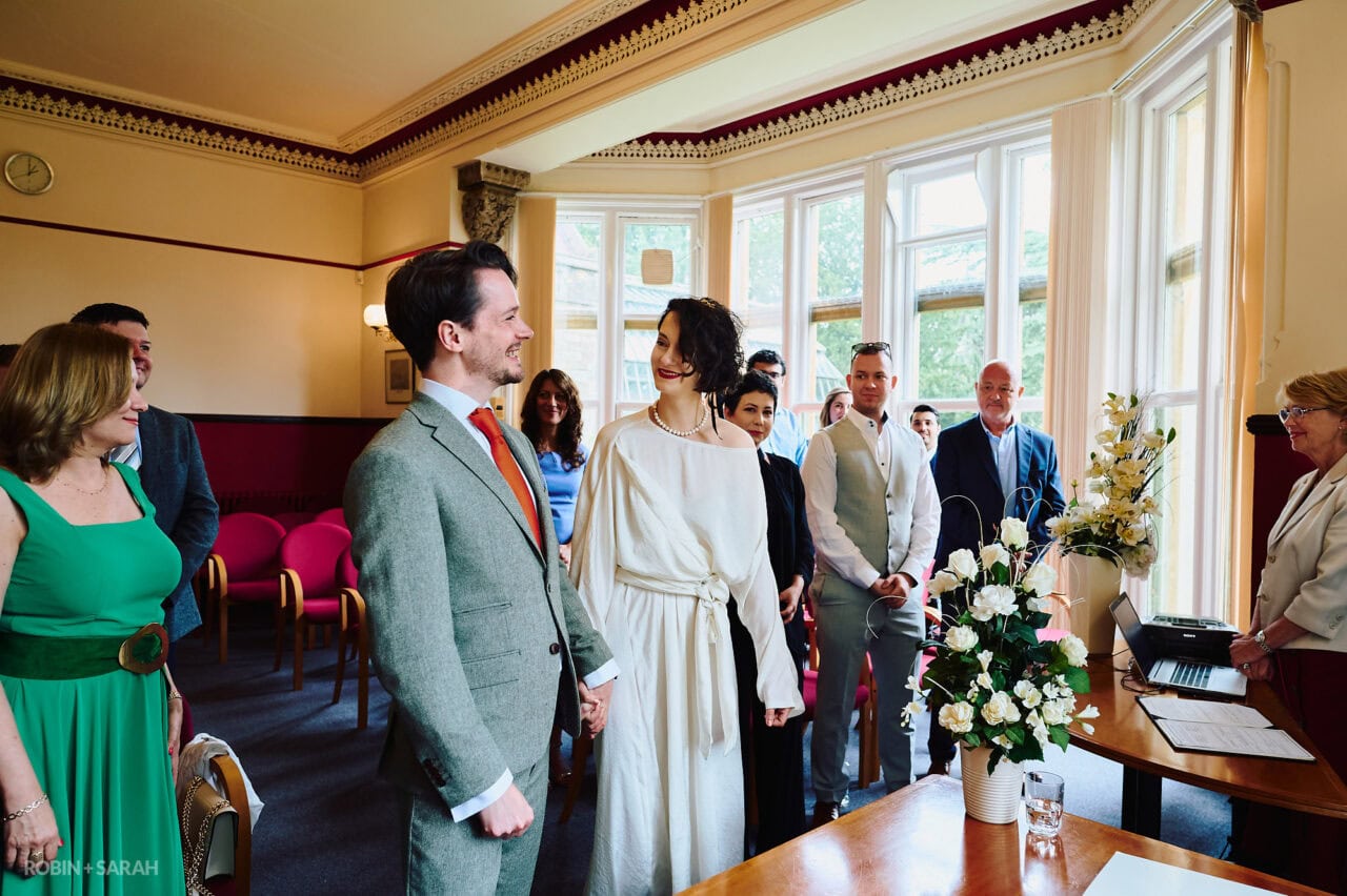 Bride and groom laughing during wedding ceremony in The Elgar Room Malvern