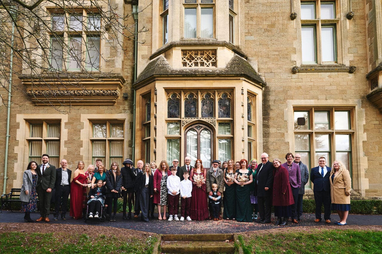 Large wedding group photo outside The Elgar Room in Malvern