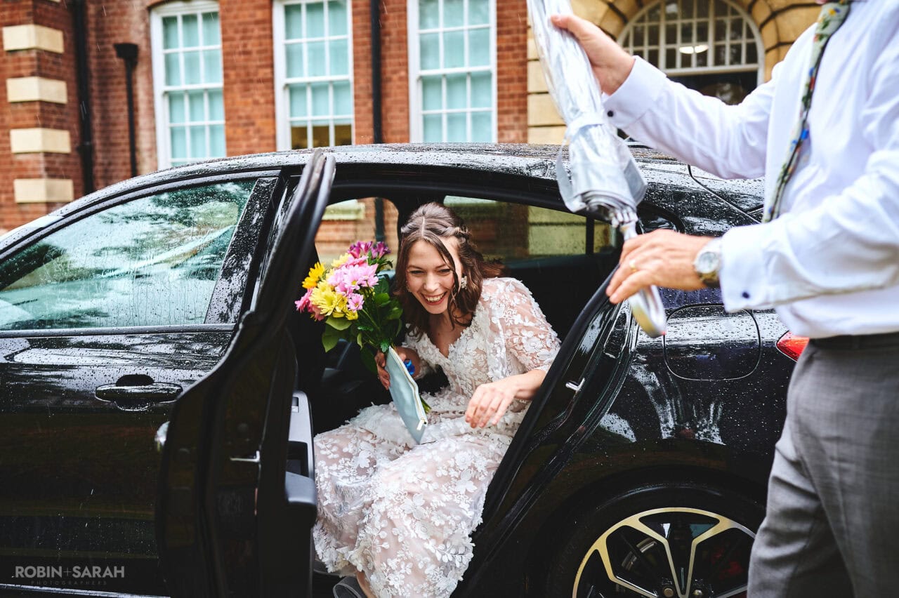 Bride steps out of wedding car as she arrives at Bromsgrove Registration Office