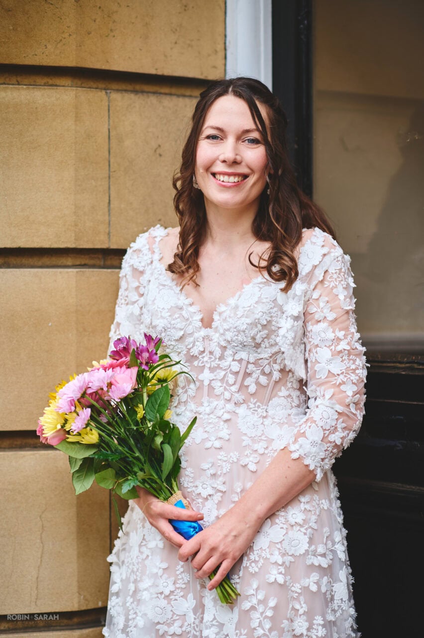 Portrait bride holding bouquet outside Bromsgrove Registry Office