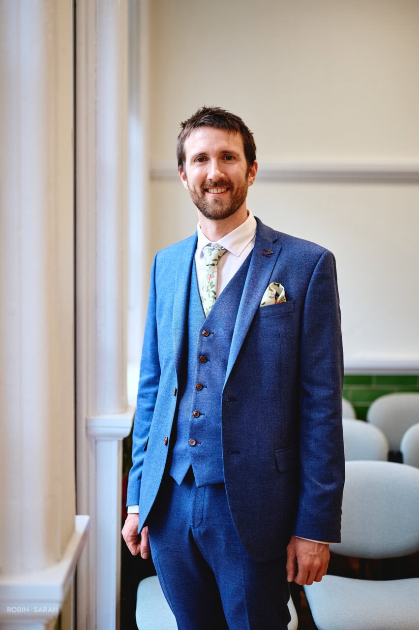 Portrait of groom in window light at Bromsgrove Registry Office