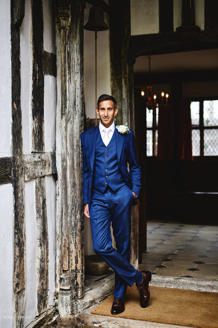 Portrait of groom standing in doorway at Greyfriars