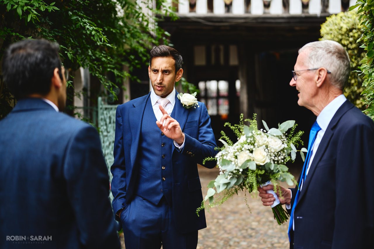 Groom chats with wedding guests