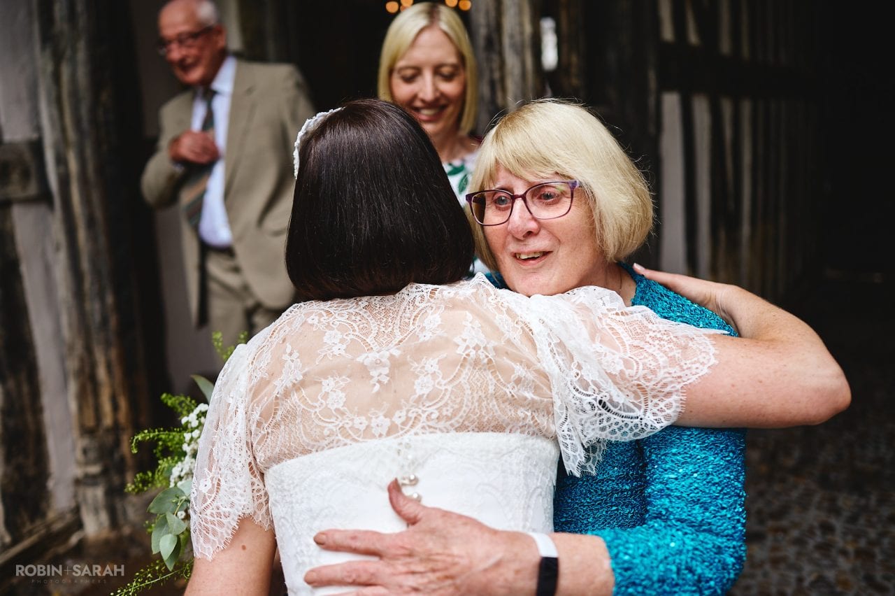 Wedding guests congratulate bride and groom after ceremony