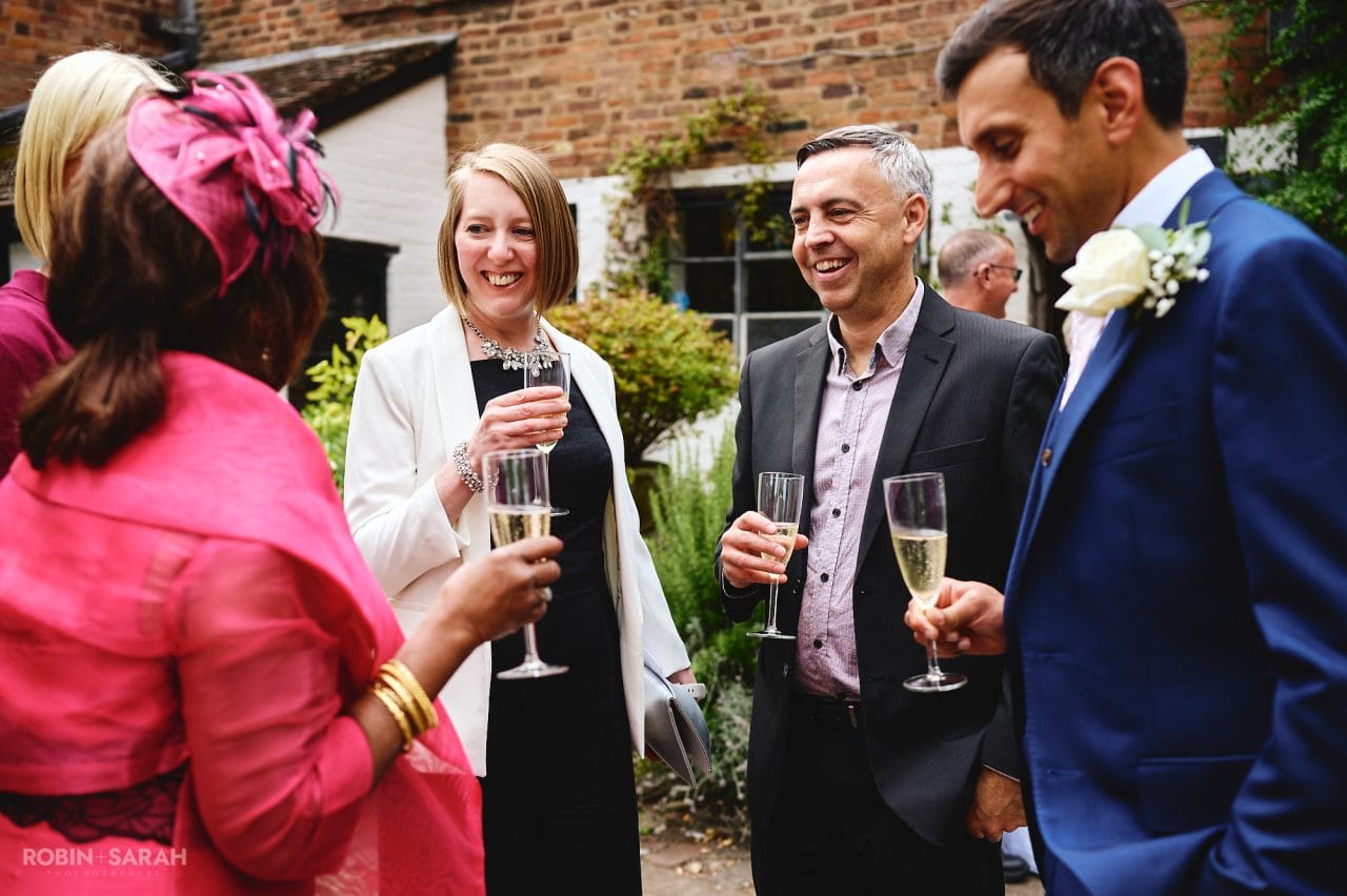 Guests chat and relax at wedding held at Greyfriars