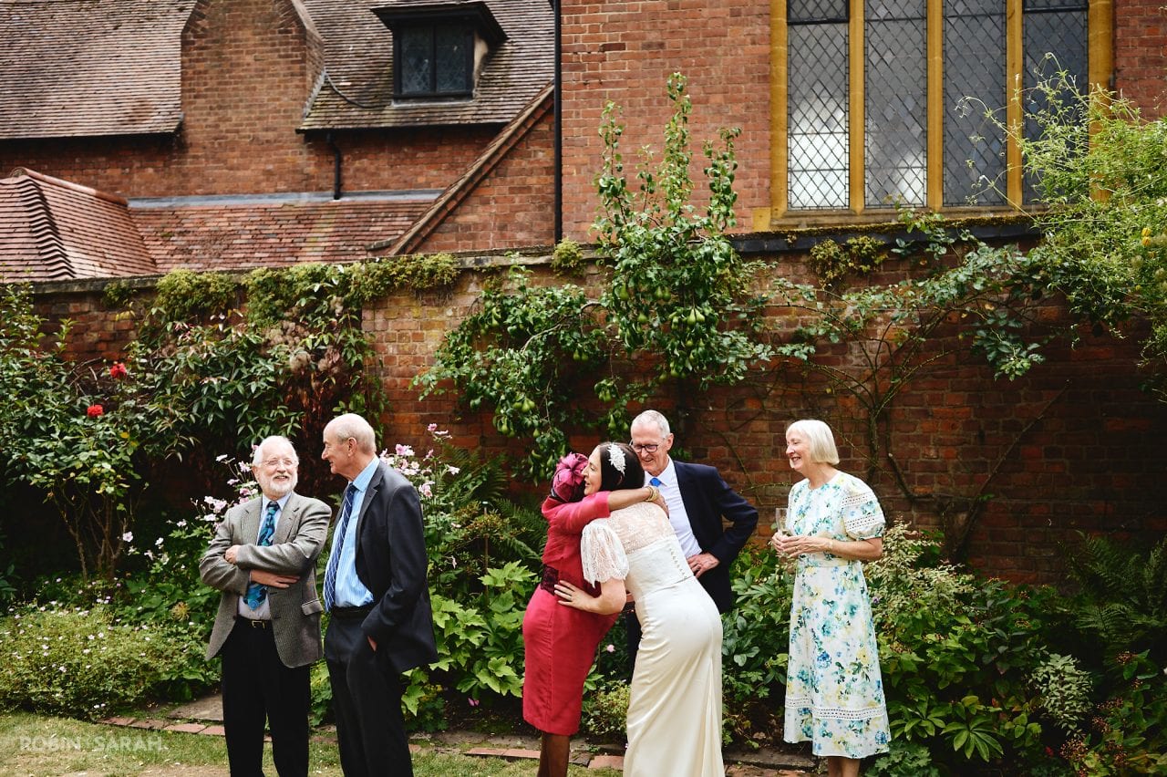 Wedding guests chat and relax in gardens at Greyfriars Worcester
