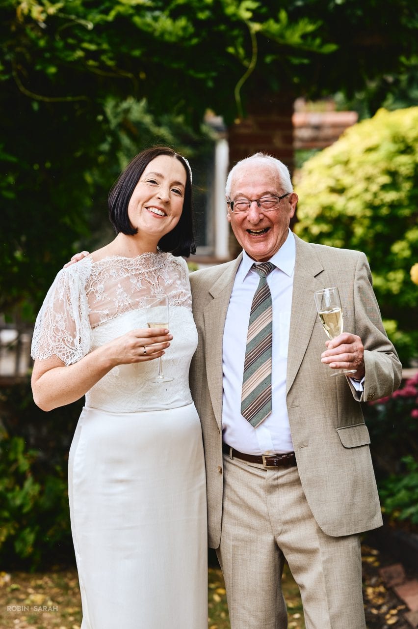 Bride and grandfather enjoying a laugh together