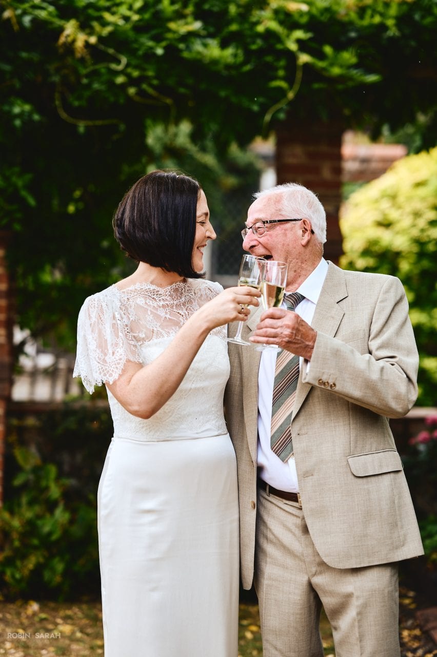 Bride and grandfather enjoying a laugh together