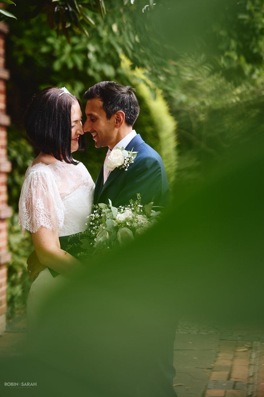 Bride and groom enjoying a quiet moment together in beautiful gardens at Greyfriars