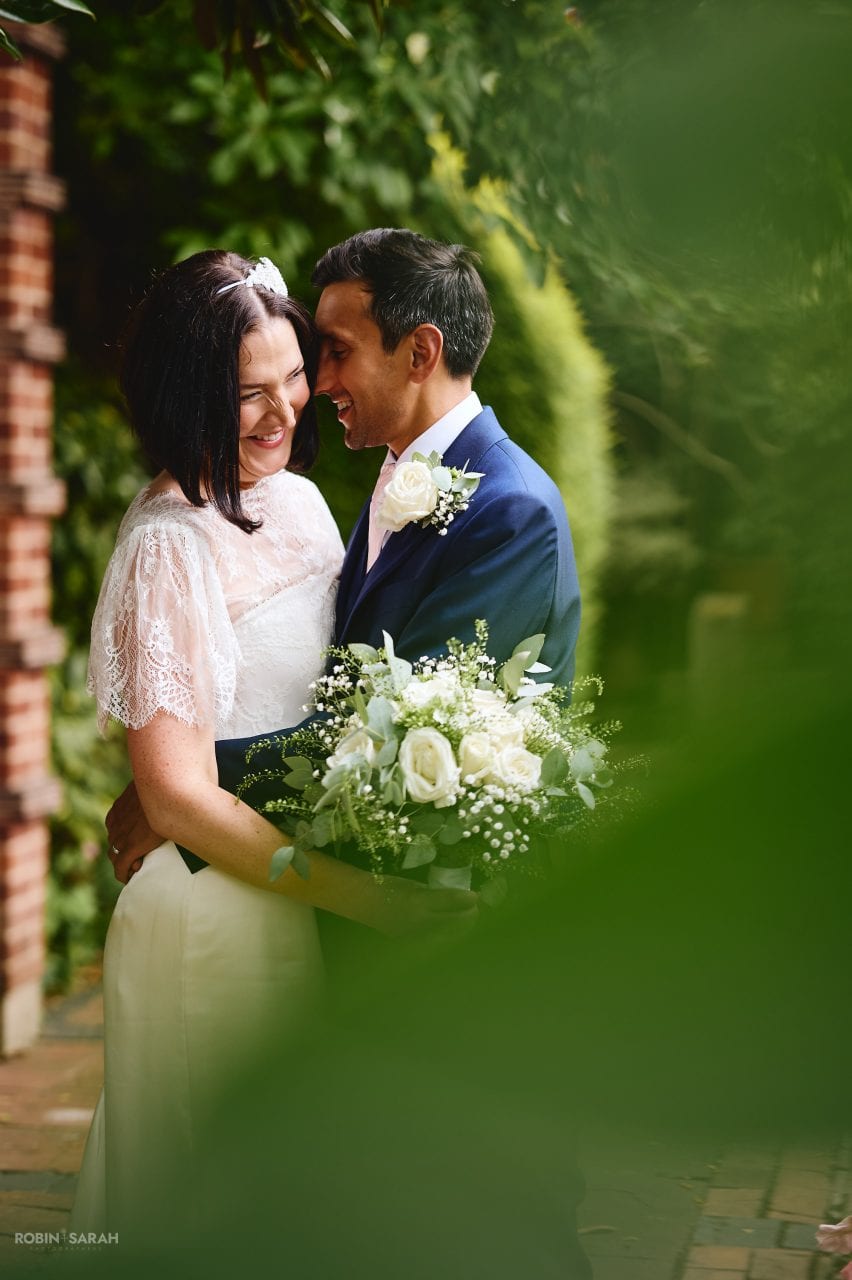 Bride and groom enjoying a quiet moment together in beautiful gardens at Greyfriars