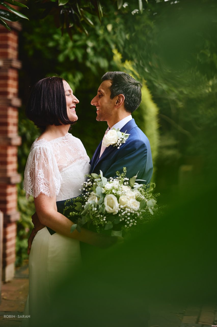 Bride and groom enjoying a quiet moment together in beautiful gardens at Greyfriars