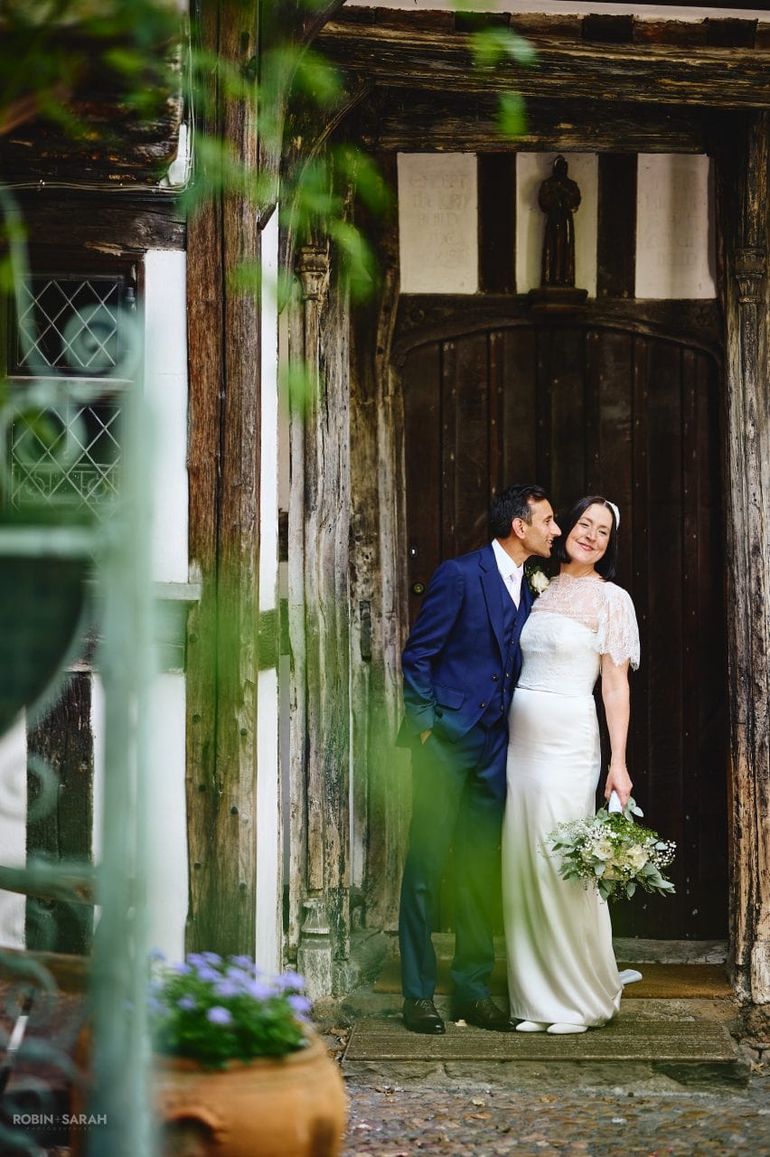 Bride and groom having fun around the old building at Greyfriars