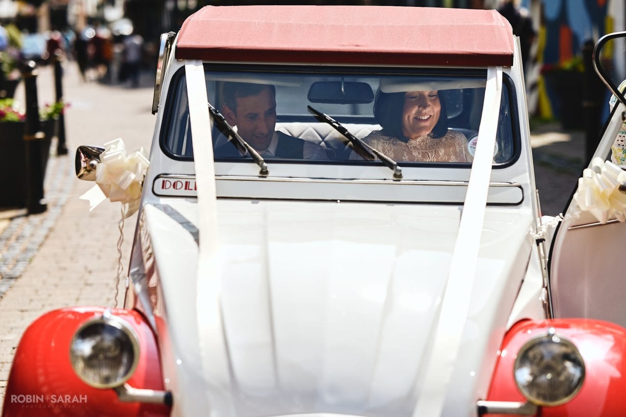 Bride and groom in 2CV wedding car