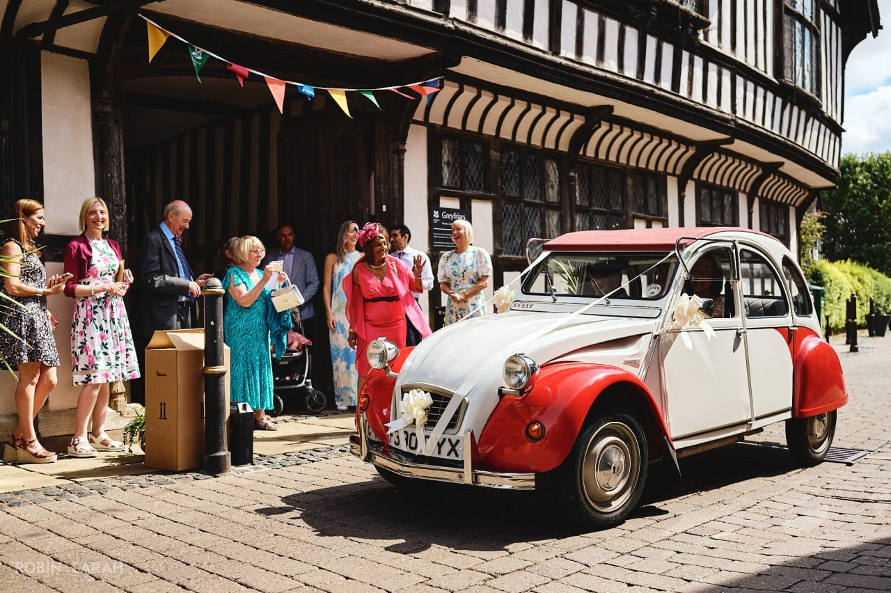 2CV wedding car outside Greyfriars in Worcester, with guests waving to bride and goom