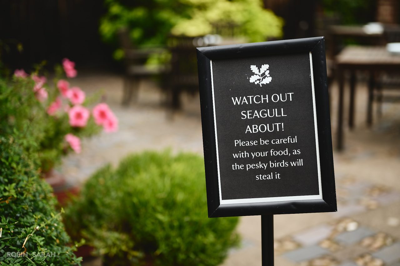 National Trust sign warning people to be aware of seagulls stealing food