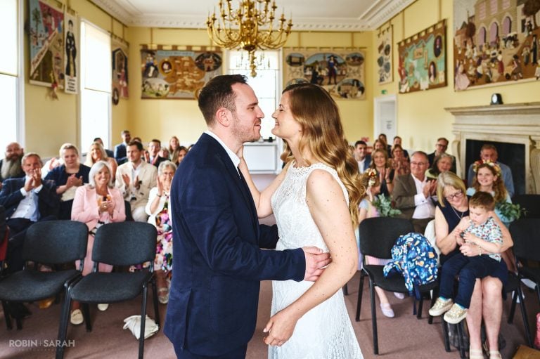 Bride and groom kiss at end of wedding ceremony