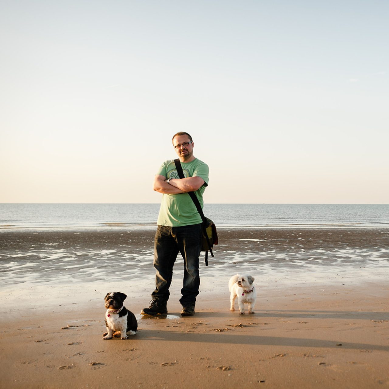 Photographer Robin standing on a beach with two dogs