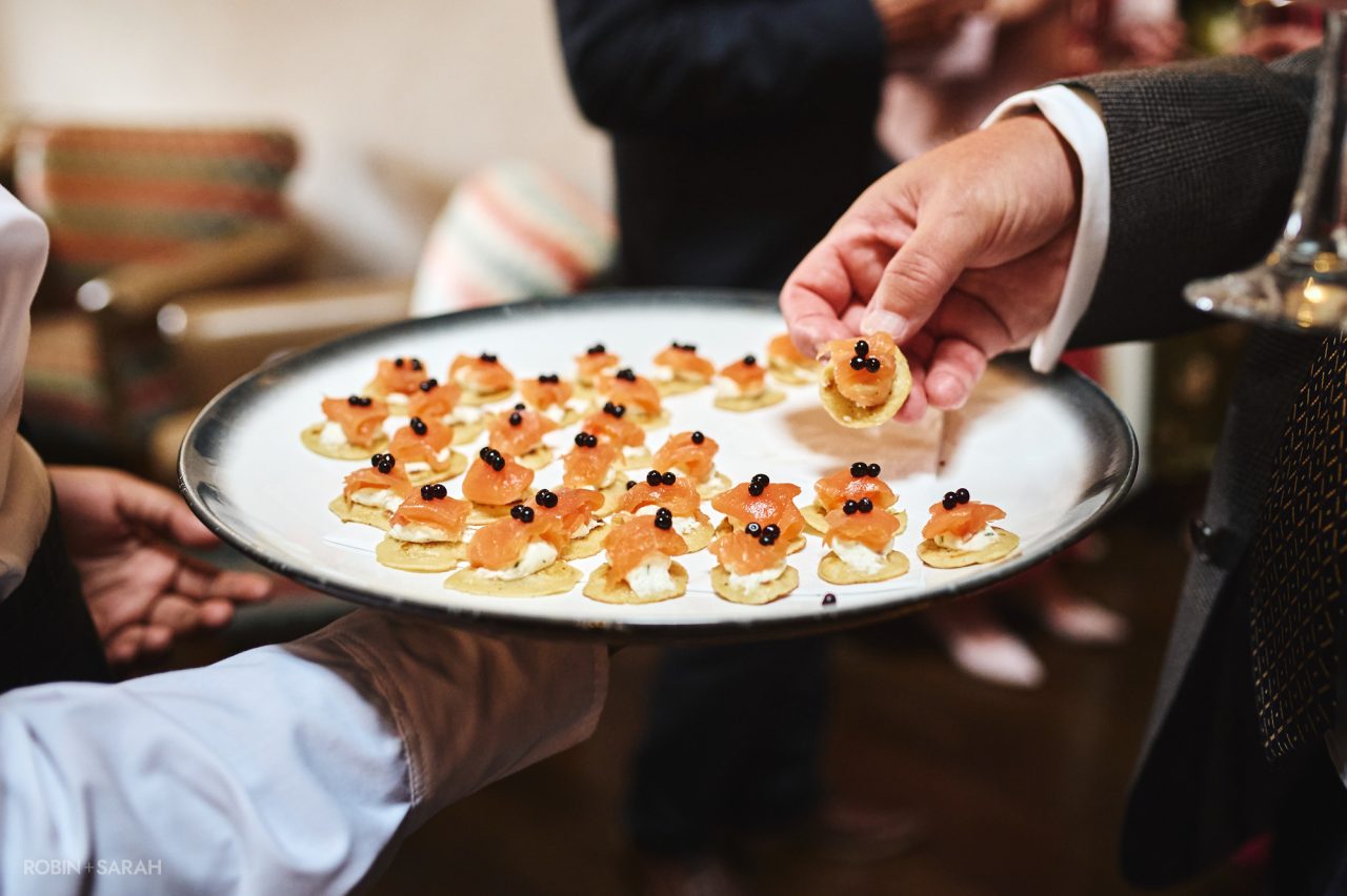 Wedding guest takes canape during wedding reception
